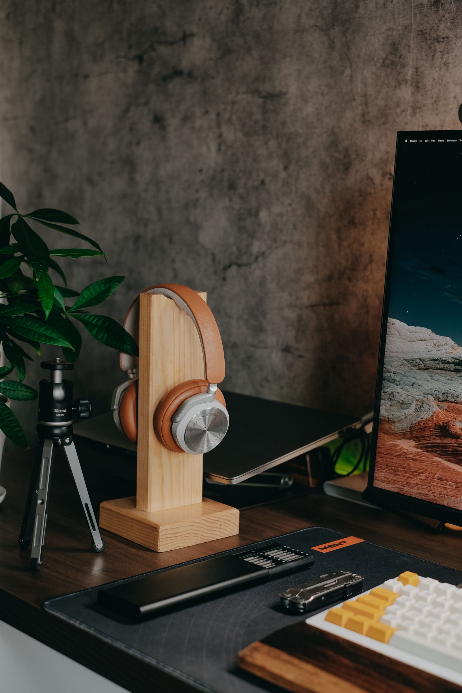 Headphones on a wooden stand at a modern workspace