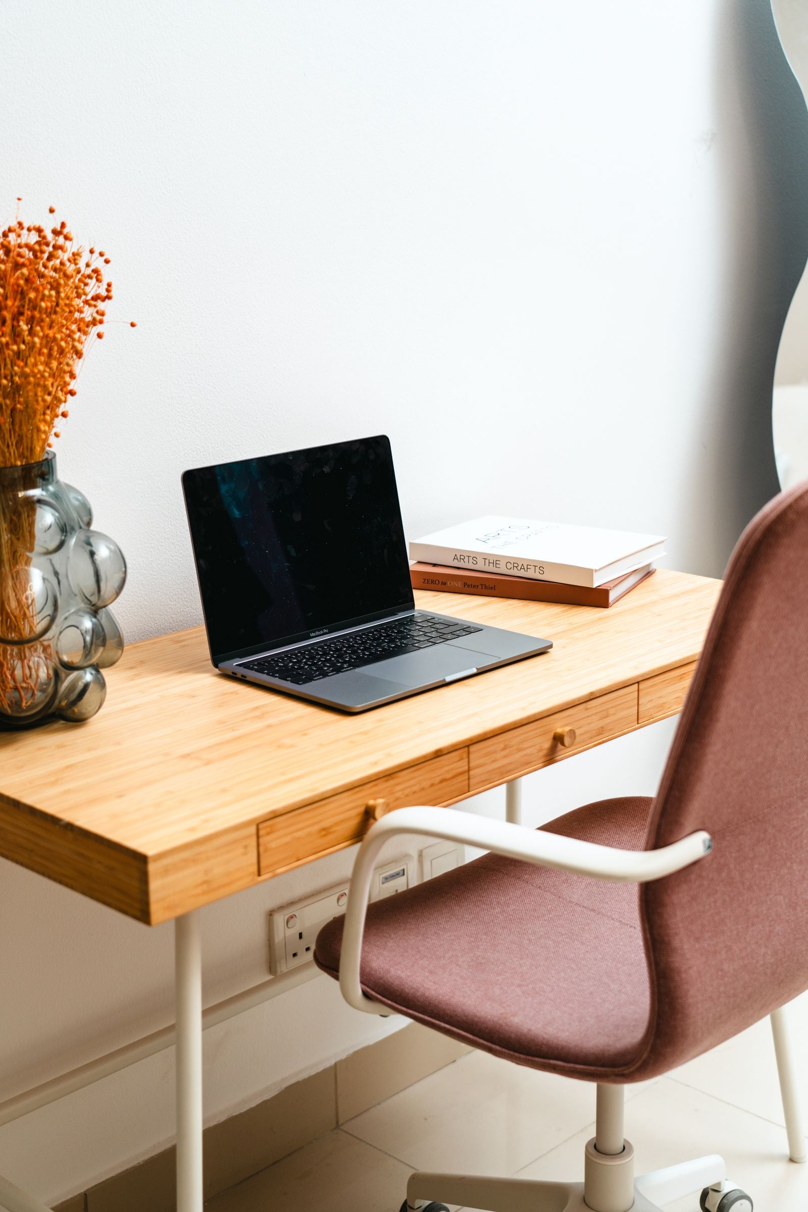 Minimalist desk setup with monitor riser and hidden storage