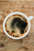 Coffee mug warmer coaster on a desk